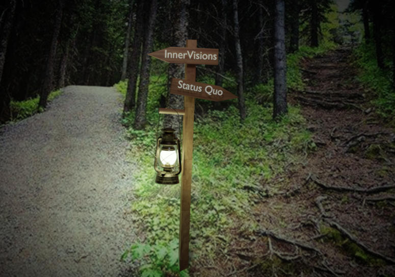 Two pathways in the woods. Left pathway is wide and clear of debris. Right pathway is littered with debris, dark and appears challenging. In the center of the two pathways is a sign post. InnerVisions points to the left, the innervisions lantern logo lightens the path. Status quo points to the right.